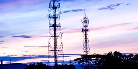 Photo of a skyline with communications towers.