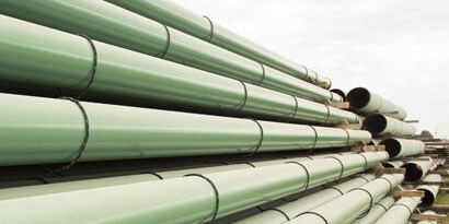 Stacked green metal pipes
