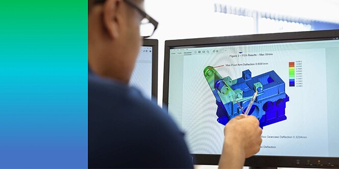 Man reviewing finite element analysis results on a computer screen
