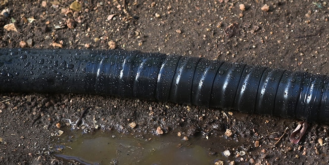 electrical cable on dirt ground wrapped in protective electrical tape
