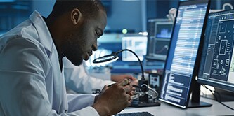 Scientist inspecting industrial interconnect components
