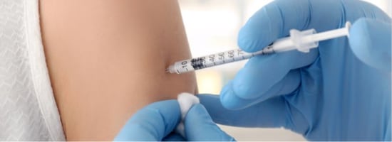 A patient receiving a COVID-19 vaccination in their arm.
