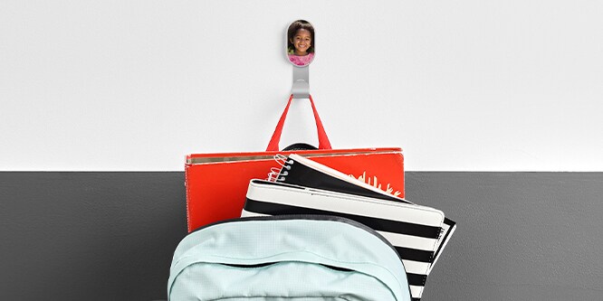 A backpack hanging from a 3M CLAW™ Photo Frame Hook
