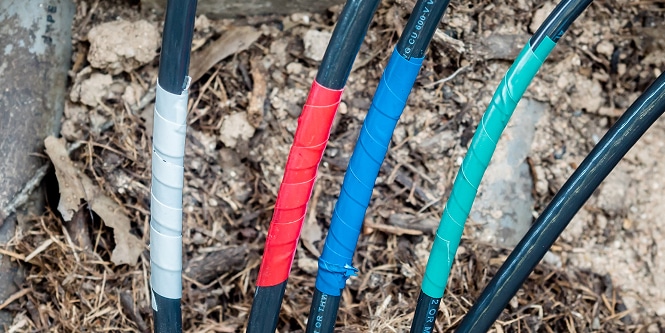 multiple electrical wires wrapped in colored electrical tape
