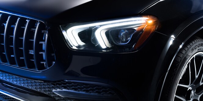 Close-up of front section of a high gloss luxury car.
