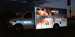 ambulance at night showing reflective graphics on the emergency vehicle for better visibility.
