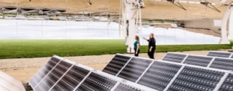 A man and a women visiting at a solar panel yard outside of a 3M™ facility in Cottage Grove, Minnesota.