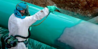 Man spraying liquid epoxy coating
