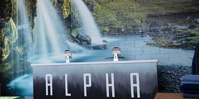 A wall has a graphic wrap with an image of a waterfall.
