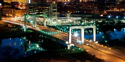 bridge in city at night with lights
